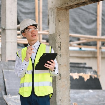 YMCA facility manager using work order management software on a tablet to track maintenance requests and equipment repairs.