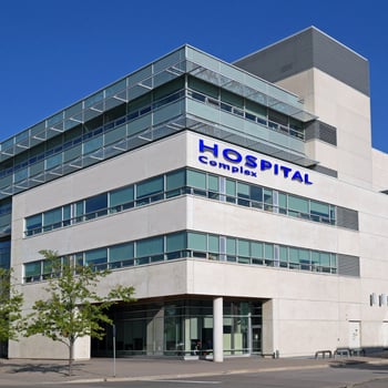 Hospital facility manager reviewing FCA checklist in a patient care area