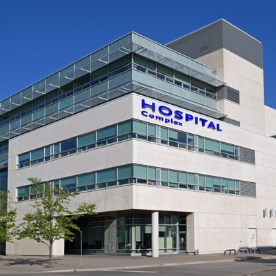 Hospital facility manager reviewing FCA checklist in a patient care area