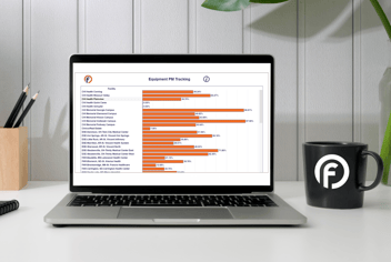 Healthcare facility manager analyzing reports on a digital dashboard