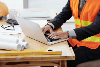 Facility Manager using CMMS on a laptop