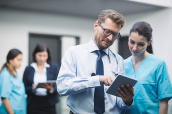 Healthcare facility manager accessing integrated systems on a digital dashboard