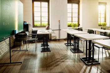 School maintenance technician inspecting HVAC system components