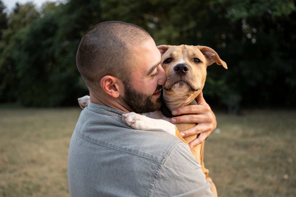 man-hugging-his-friendly-pitbull