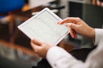 school facility manager using a digital dashboard on a tablet