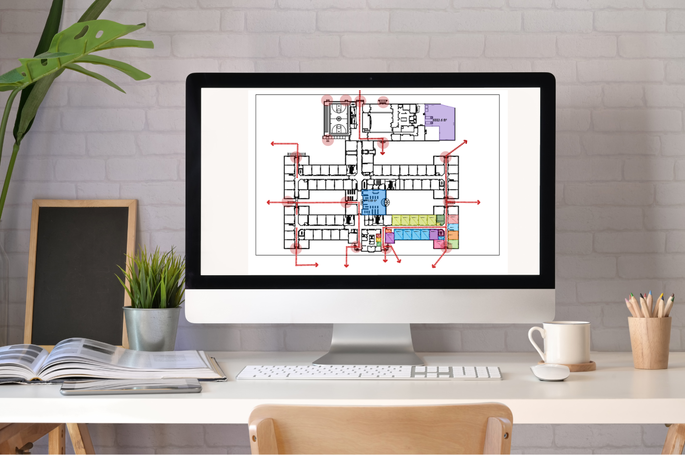 Healthcare facility manager reviewing digital floor plans on a tablet
