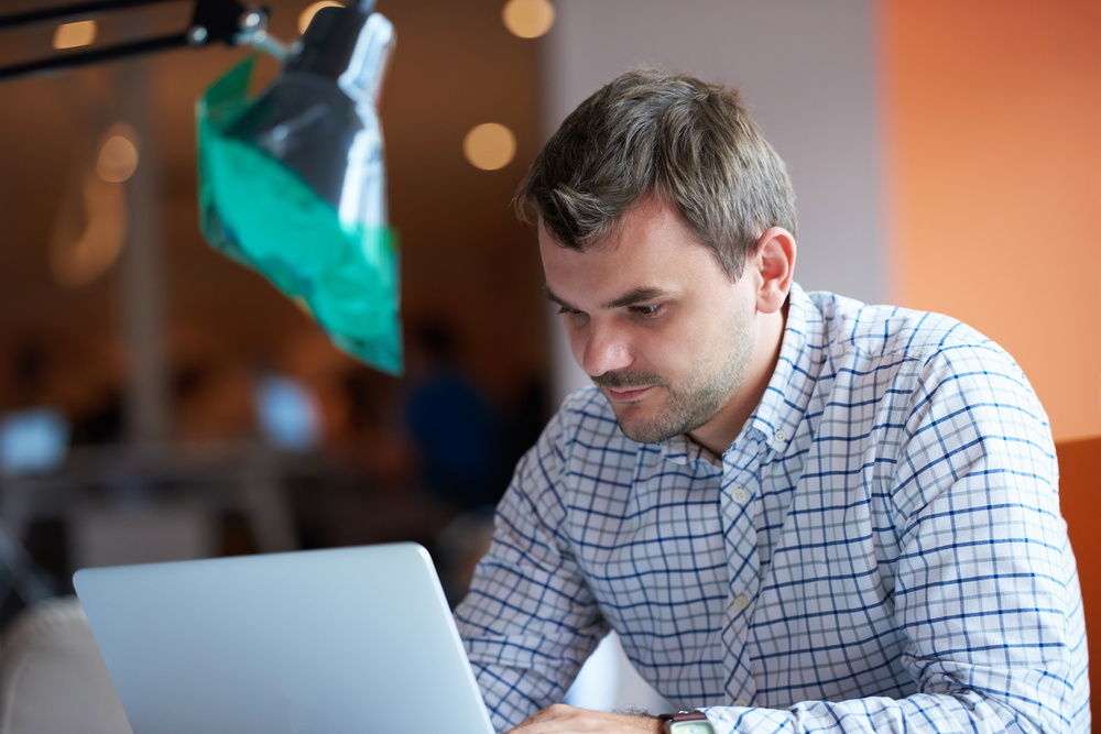 YMCA software developer working on computer 